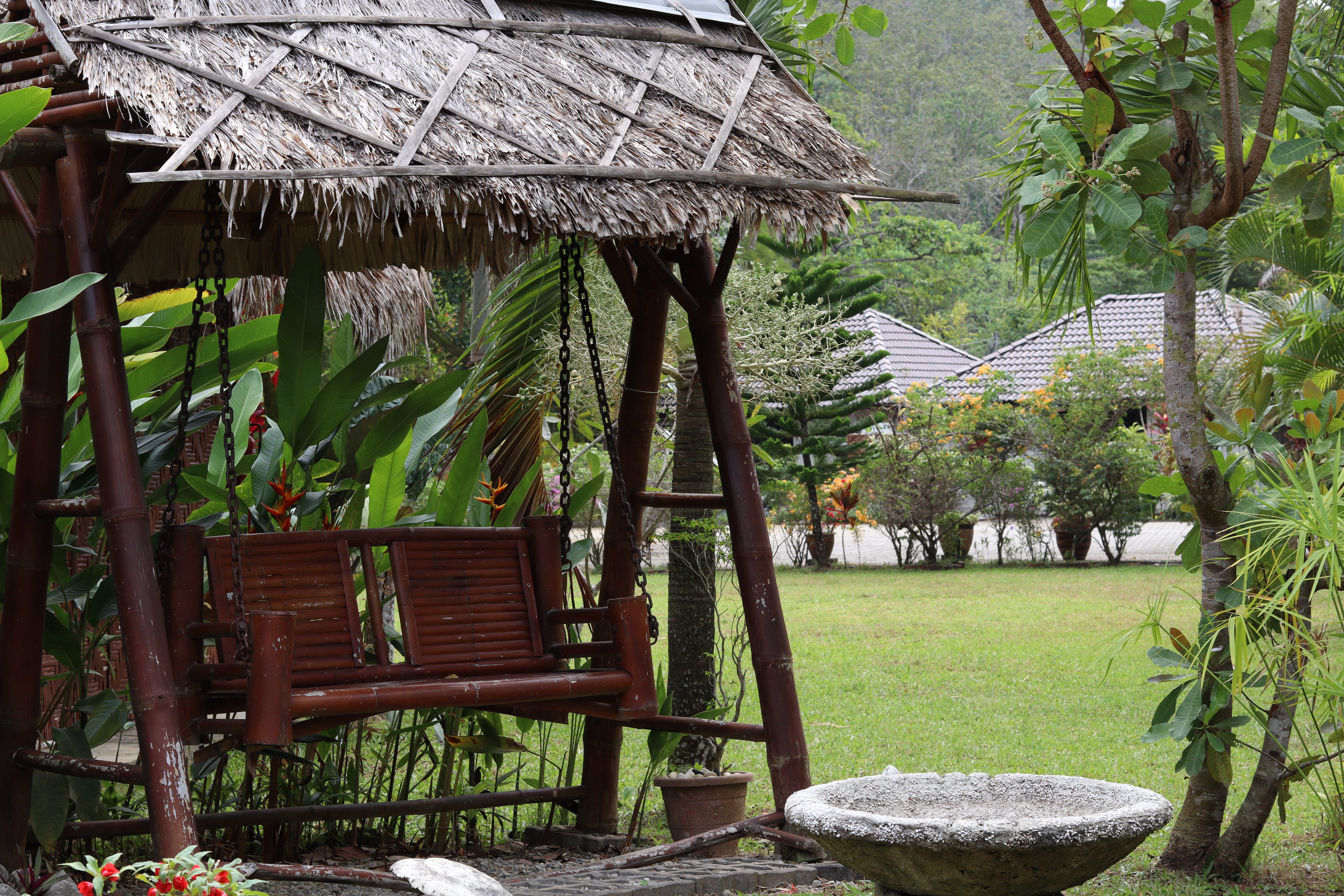 Tropical gardens and walkways between buildings at Bambu compound