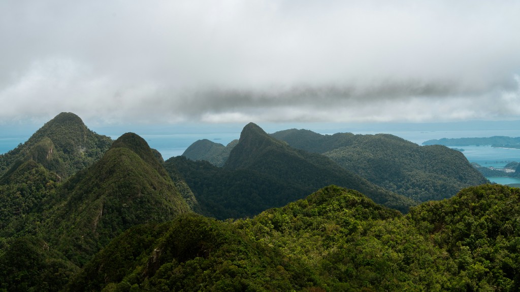 Mist-covered forested limestone peaks of Langkawi UNESCO Geopark with the Andaman Sea and distant islands beyond